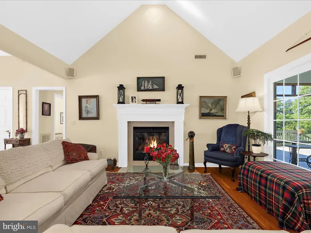 a dining room with furniture and a floor to ceiling window