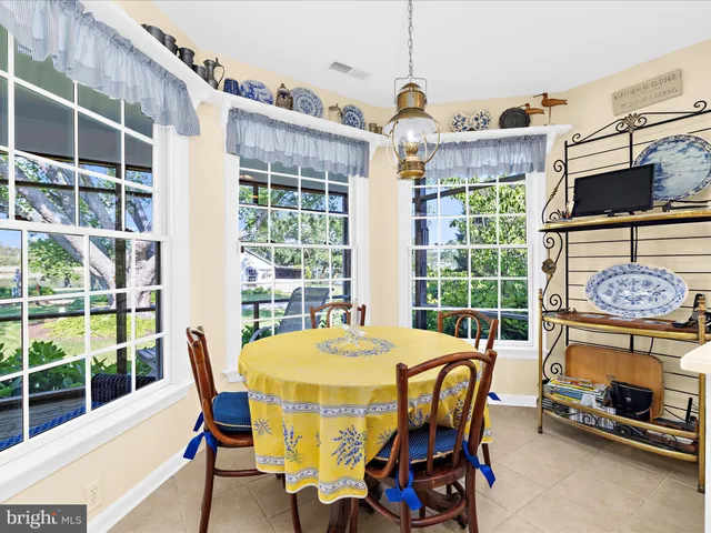 a kitchen with granite countertop white cabinets and a stove top oven