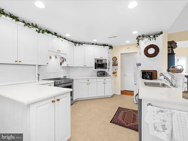 a large white kitchen with a large window