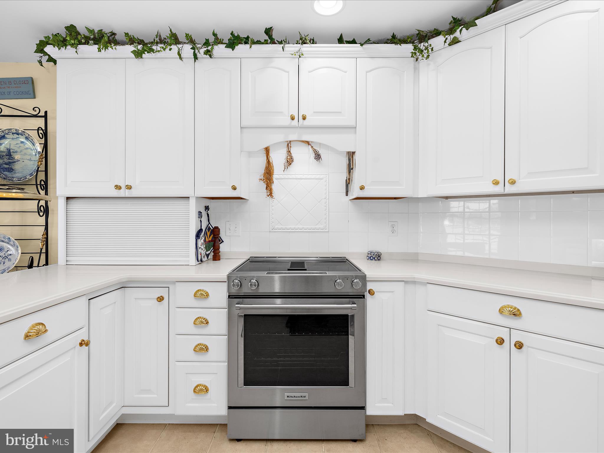 8698 Cummings Road Wittman, MD 21676 - Photo 15 of 63 a kitchen with granite countertop white cabinets and a stove top oven