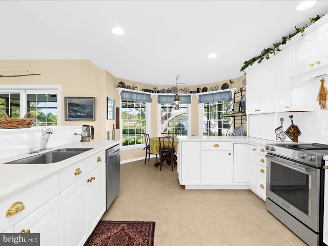 a kitchen with kitchen island white cabinets and refrigerator