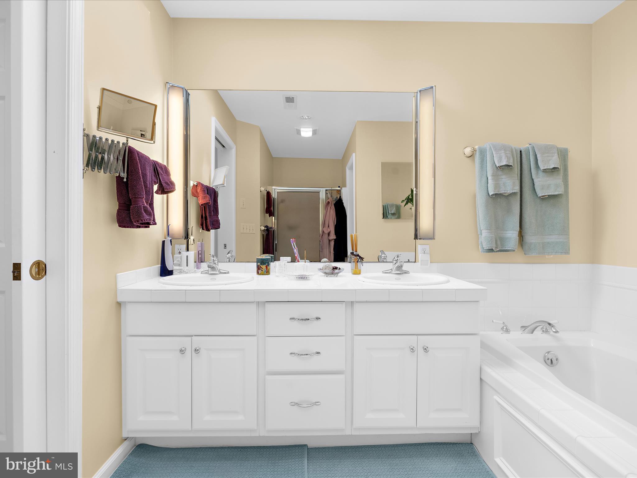 8698 Cummings Road Wittman, MD 21676 - Photo 26 of 63 a bathroom with a double vanity sink mirror and bathtub