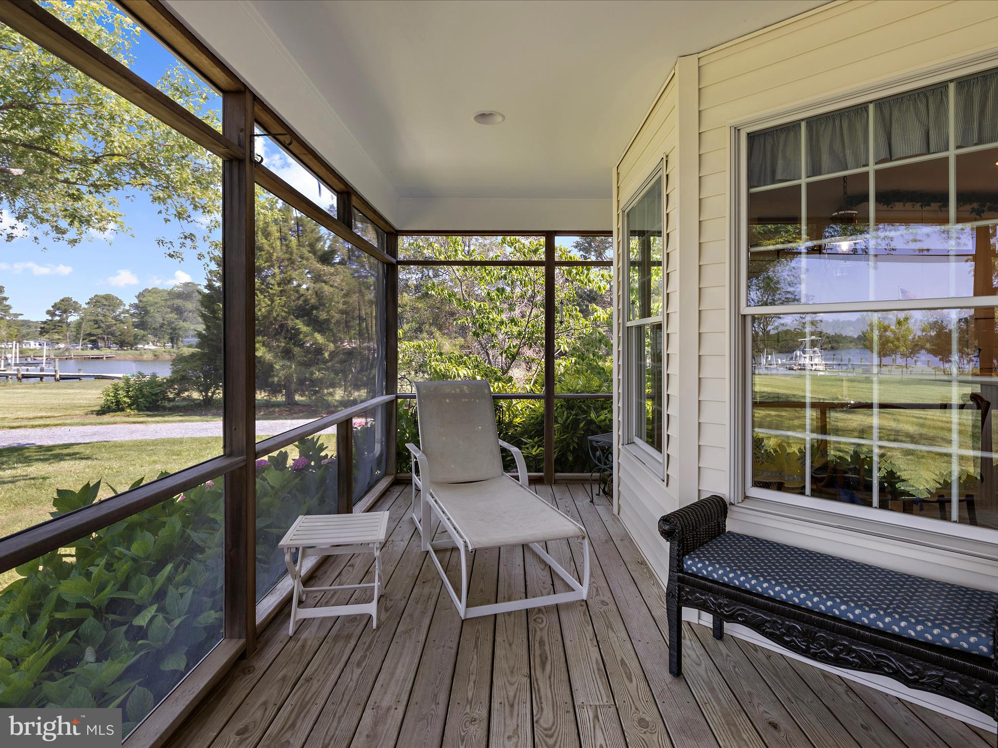 8698 Cummings Road Wittman, MD 21676 - Photo 36 of 63 a view of a balcony with wooden floor and outdoor space