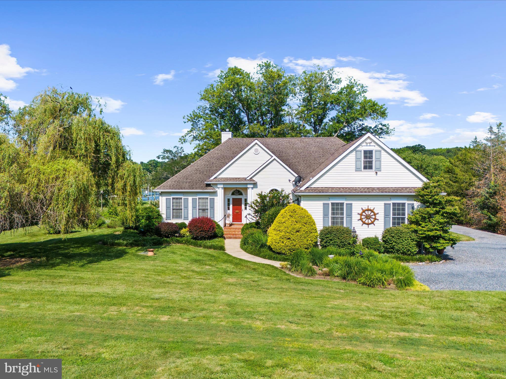 8698 Cummings Road Wittman, MD 21676 - Photo 4 of 63 a front view of a house with a garden and trees