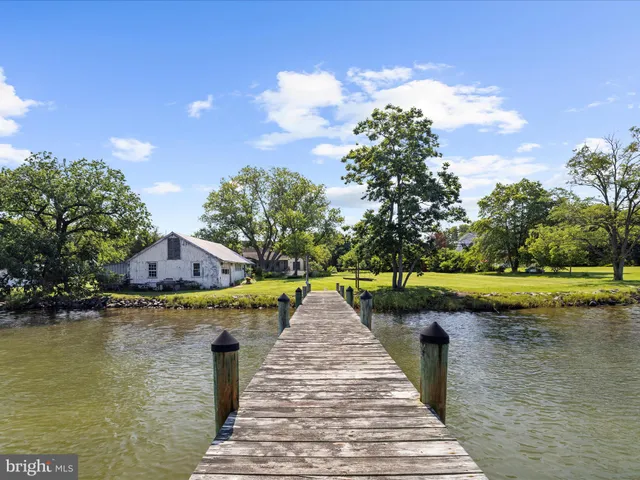 an aerial view of a house with a swimming pool yard and outdoor seating