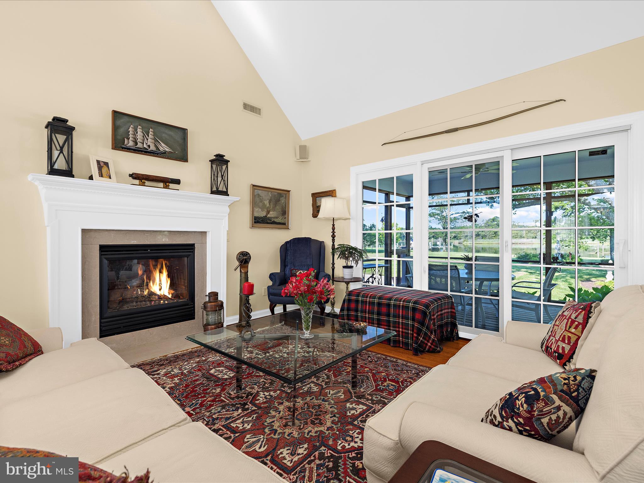 8698 Cummings Road Wittman, MD 21676 - Photo 10 of 63 a living room with furniture a fireplace and floor to ceiling windows