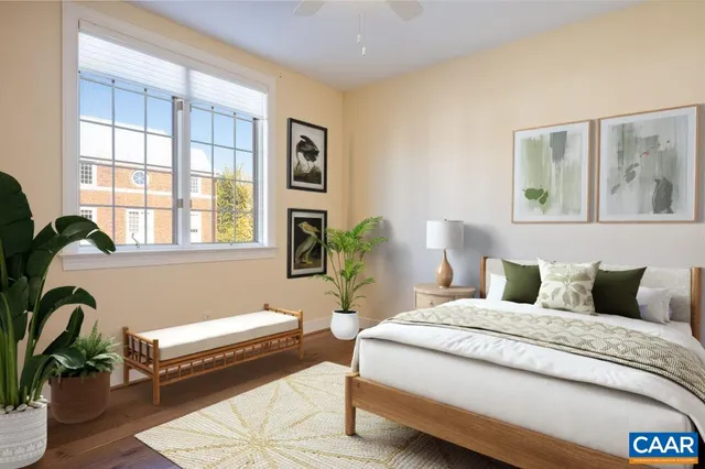 a bedroom with a bed wooden floor and window