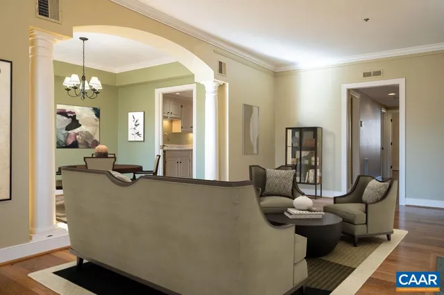 a living room with furniture and wooden floor