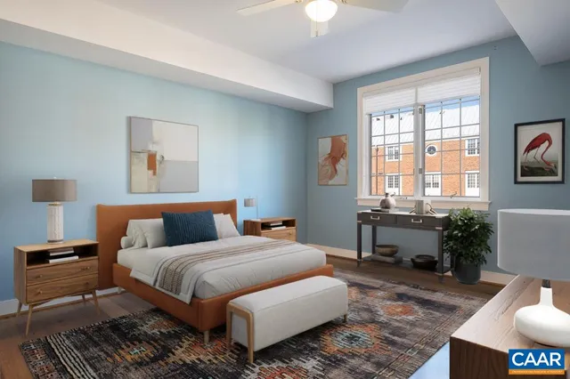 a bedroom with a bed and wooden floor