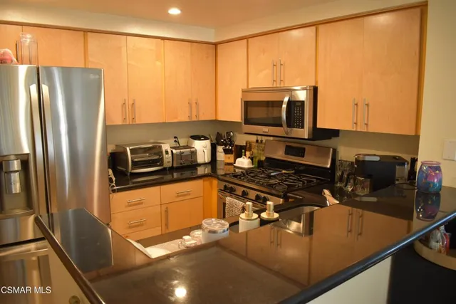 a kitchen with a refrigerator stove and microwave