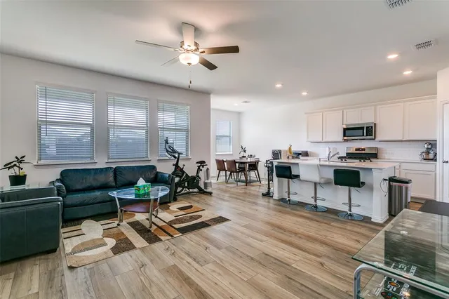 a kitchen with appliances cabinets and chair