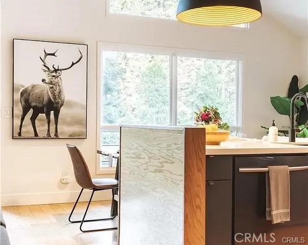 a room with a table chairs and a large window