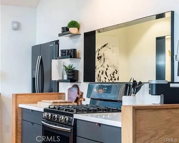 a kitchen with stainless steel appliances granite countertop a stove and a refrigerator
