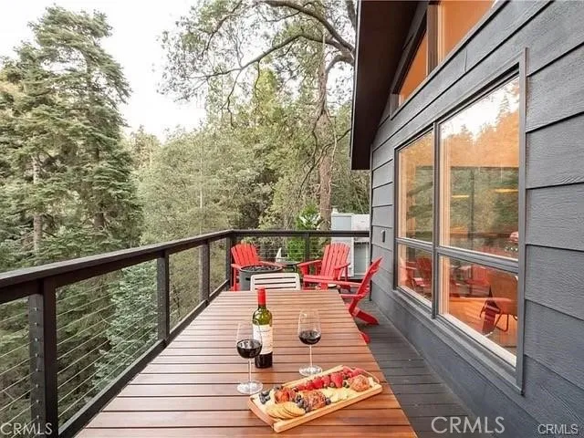 a balcony with wooden floor and outdoor seating