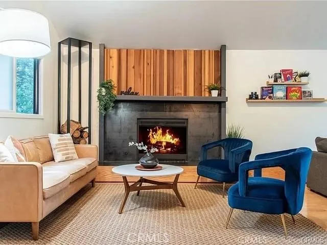 a living room with furniture fireplace and a table