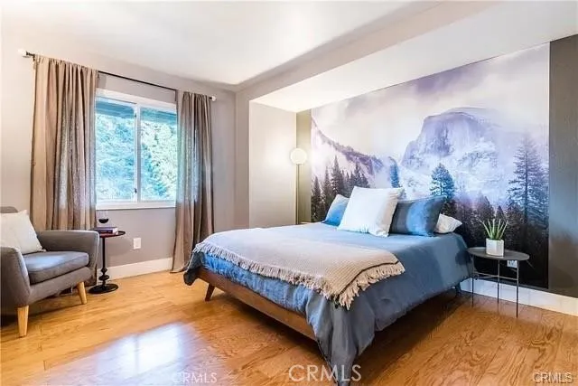 a bedroom with a bed chair and a window