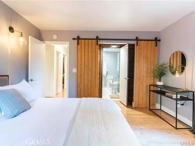 a bedroom with a bed and a mirror