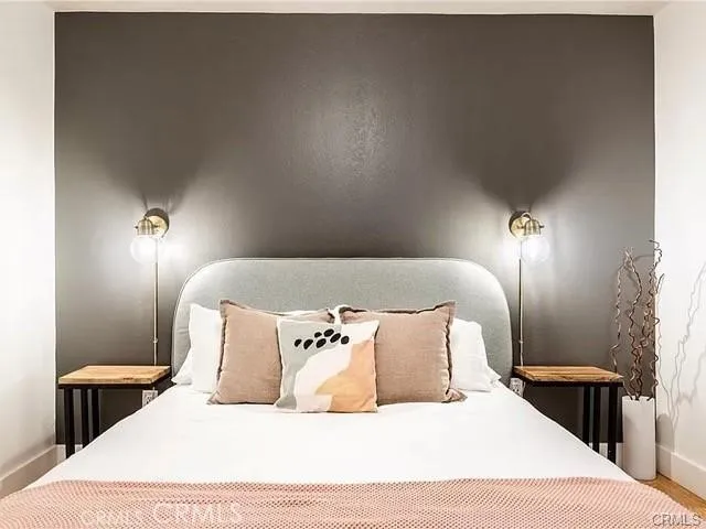 a large bed sitting in a bedroom and lamp