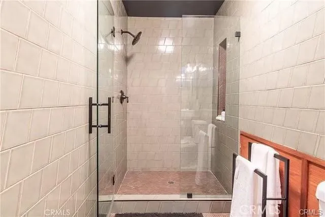 a bathroom with a glass shower door