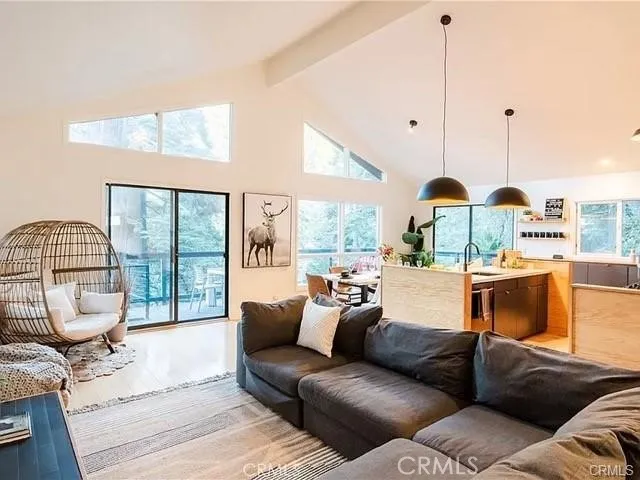 a living room with furniture and a floor to ceiling window