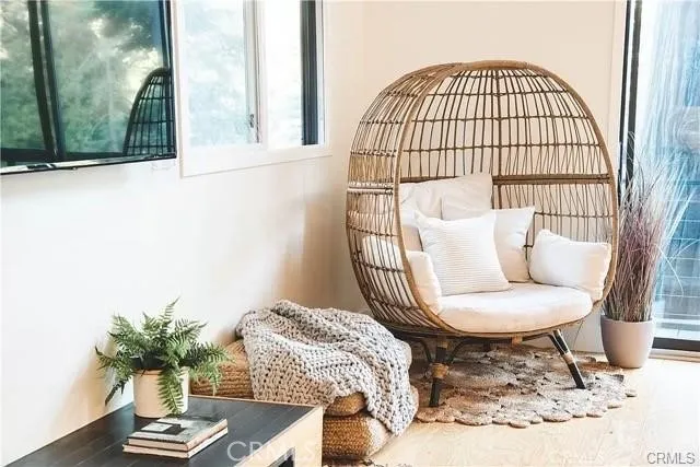 a living room with a couch and a potted plant