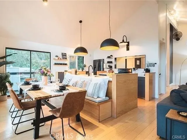 a dining room with furniture and large windows