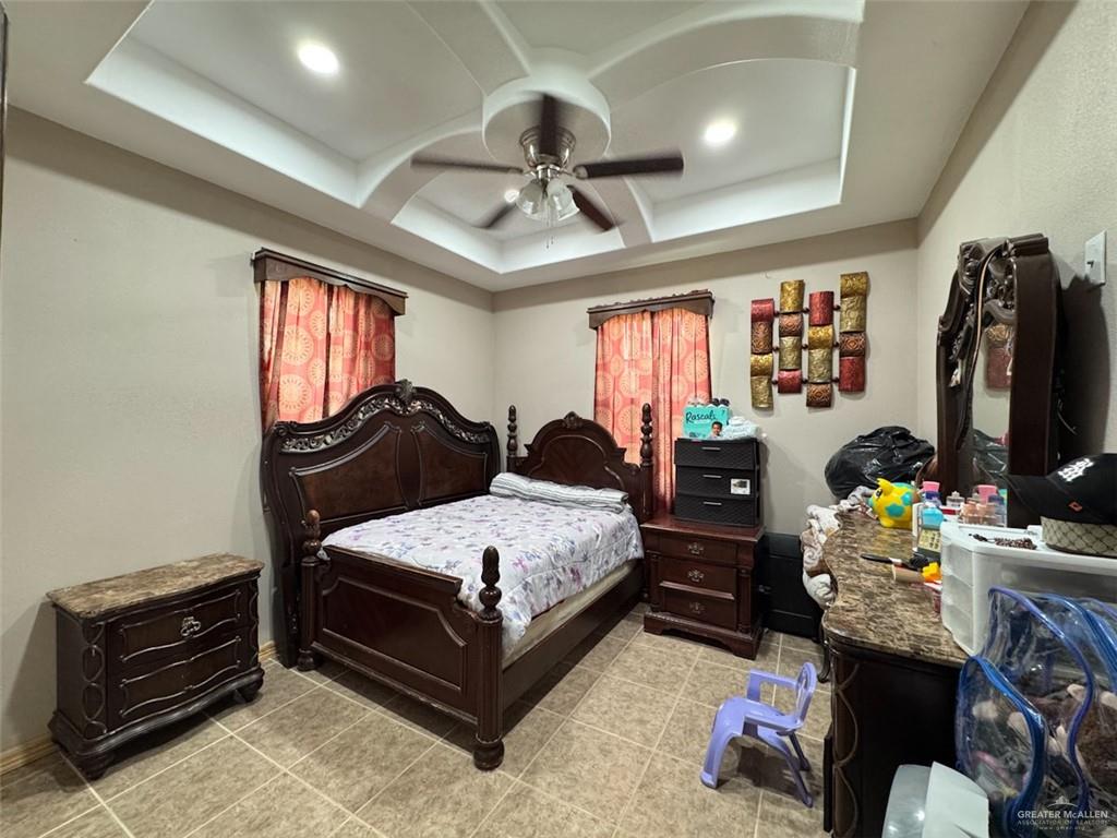 23960 North Texan Road Edinburg, TX 78541 - Photo 14 of 31 a bedroom with a bed closet and flat tv screen