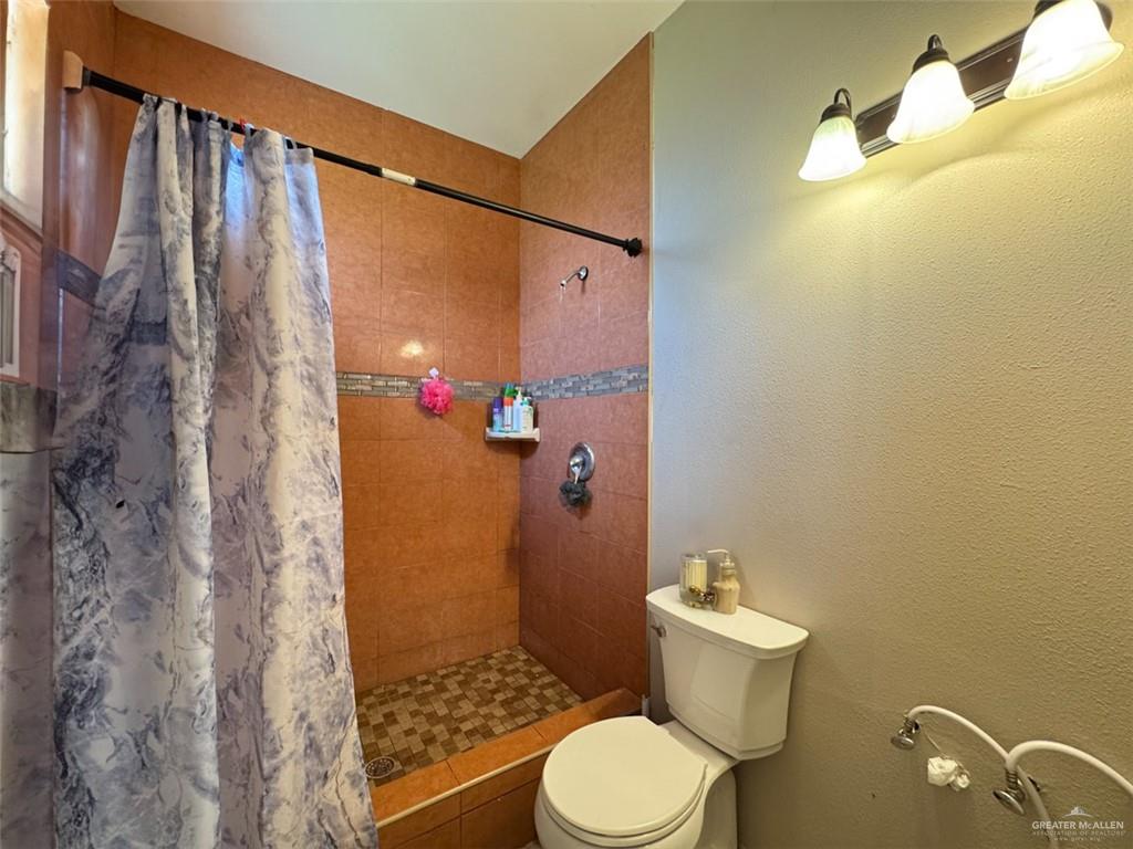 23960 North Texan Road Edinburg, TX 78541 - Photo 15 of 31 a bathroom with a sink toilet and shower