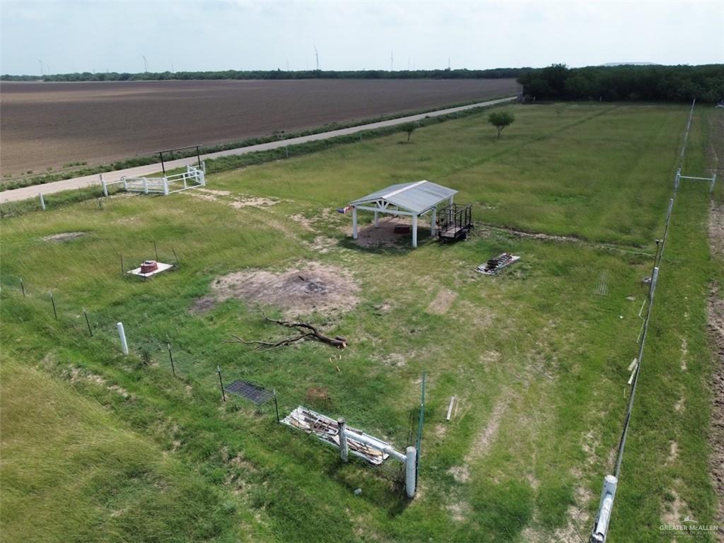 23960 North Texan Road Edinburg, TX 78541 - Photo 23 of 31 a backyard of a house with lots of green space