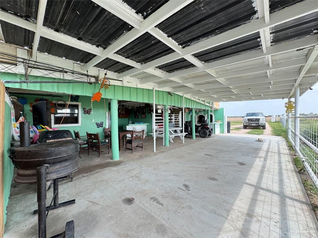 23960 North Texan Road Edinburg, TX 78541 - Photo 30 of 31 a view of a garage with wooden table and chairs
