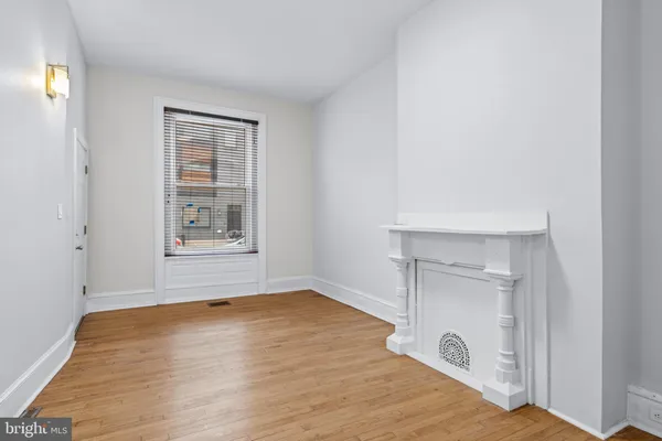 an empty room with windows and closet