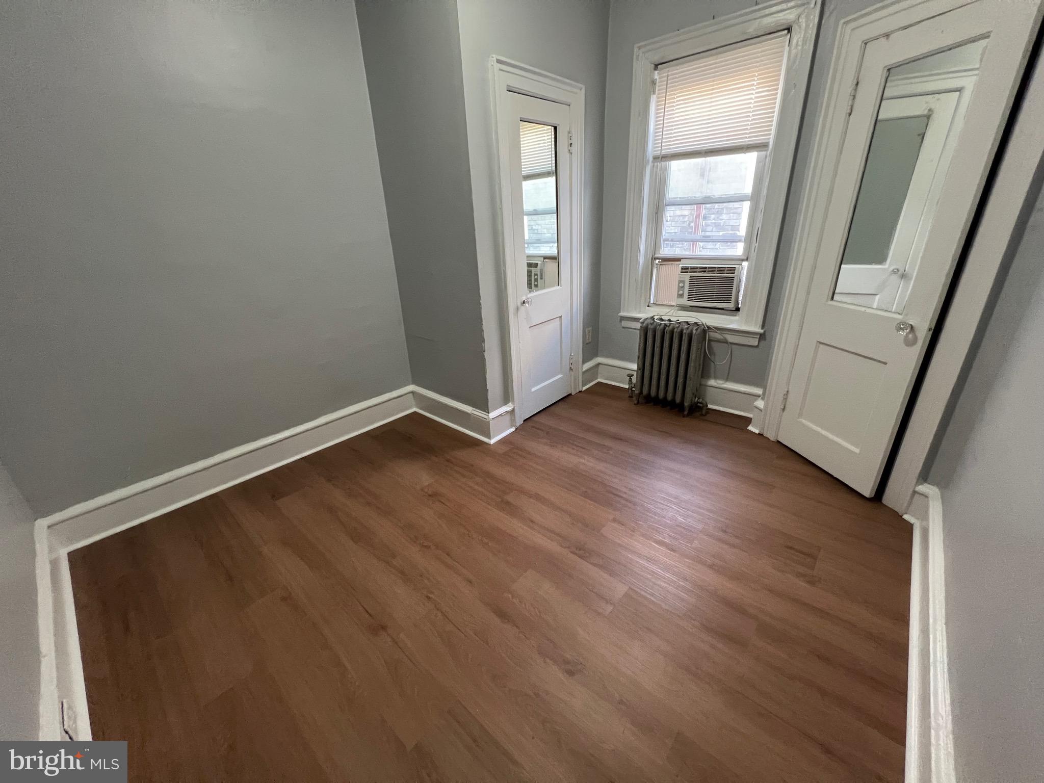 5533 Walnut Street, Unit 2 Philadelphia, PA 19139 - Photo 12 of 23 an empty room with wooden floor and windows