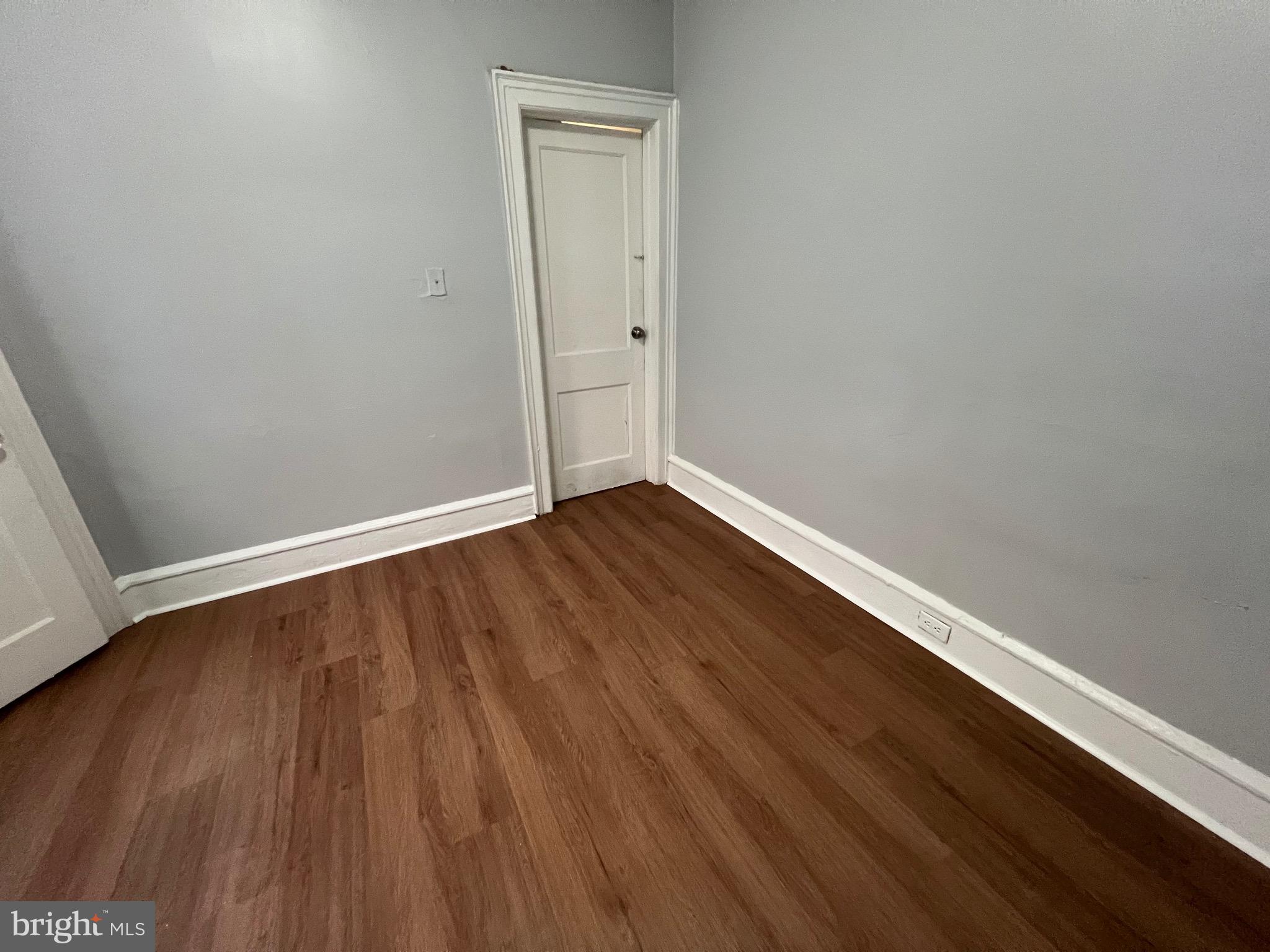 5533 Walnut Street, Unit 2 Philadelphia, PA 19139 - Photo 13 of 23 a view of an empty room with wooden floor and a window
