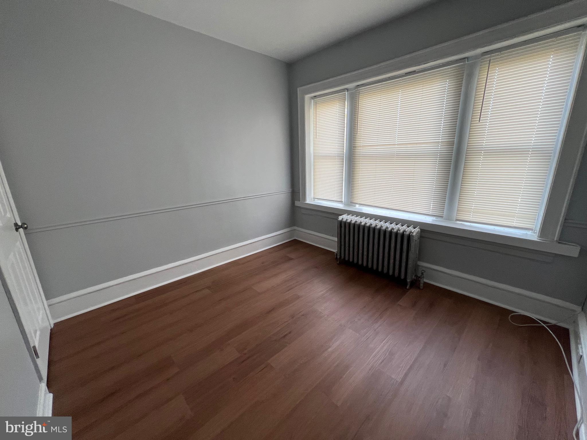 5533 Walnut Street, Unit 2 Philadelphia, PA 19139 - Photo 17 of 23 an empty room with wooden floor and windows