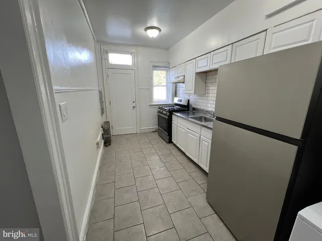 a kitchen with cabinets and steel stainless steel appliances