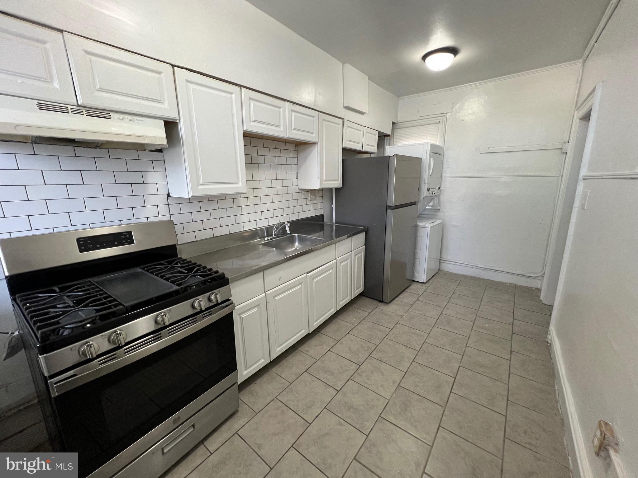 5533 Walnut Street, Unit 2 Philadelphia, PA 19139 - Photo 21 of 23 a kitchen with cabinets and steel stainless steel appliances