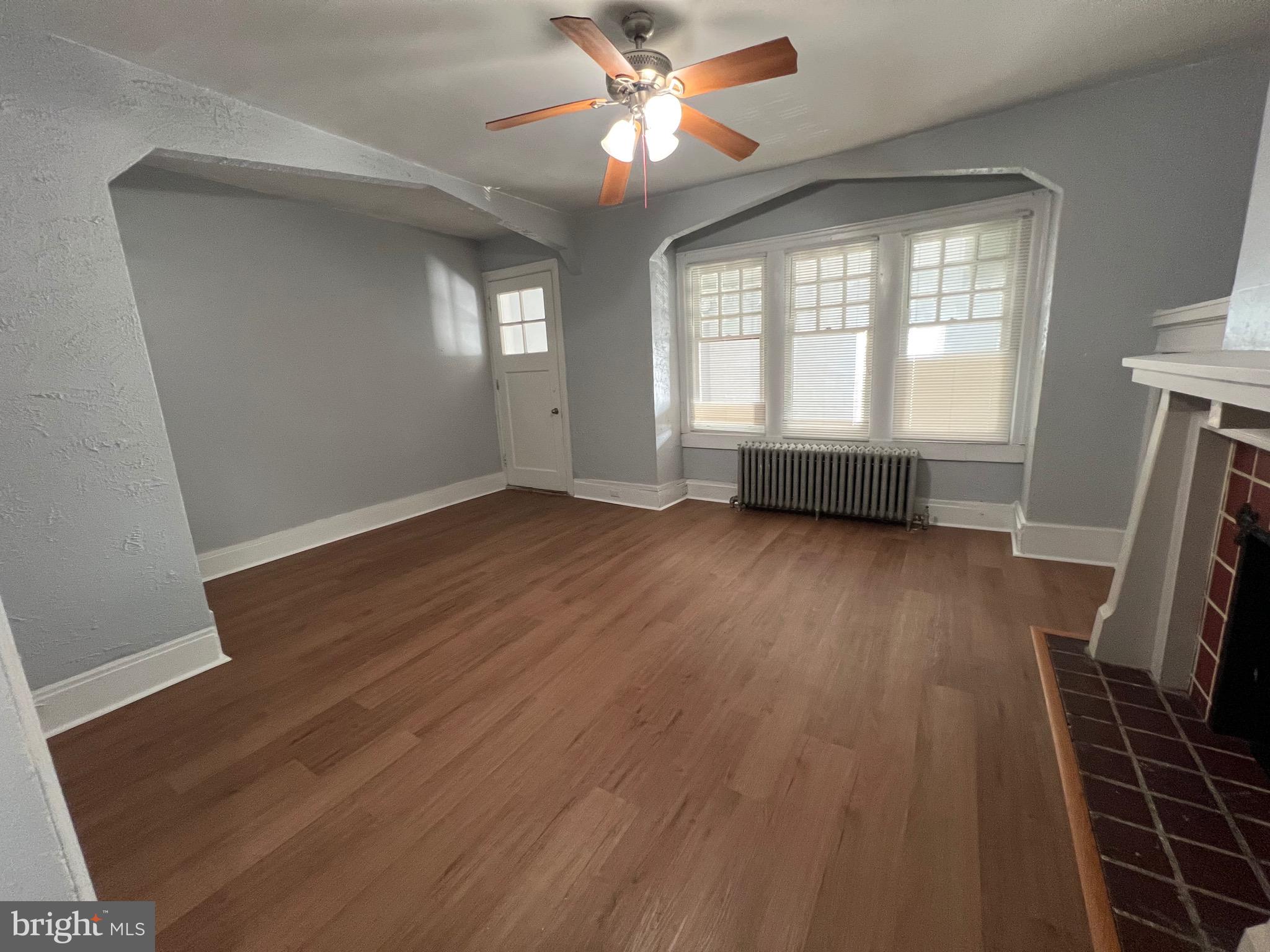 5533 Walnut Street, Unit 2 Philadelphia, PA 19139 - Photo 6 of 23 wooden floor in an empty room with a window