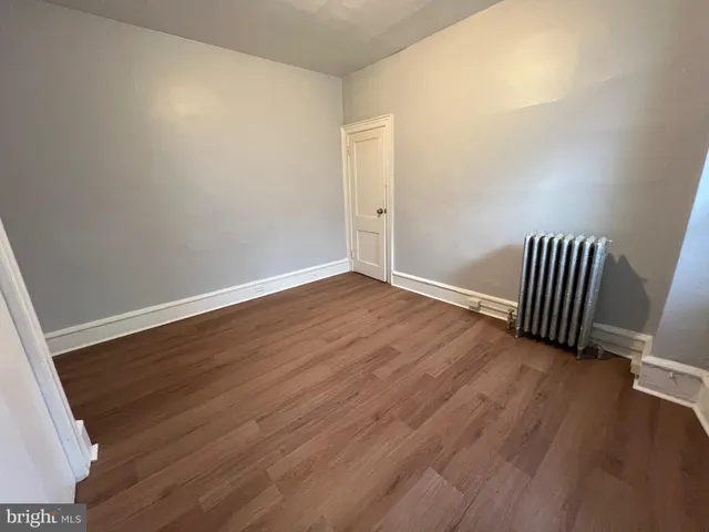 an empty room with wooden floor
