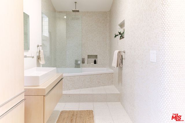 a bathroom with a double vanity sink and a mirror