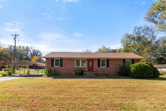 a front view of house with yard and green space