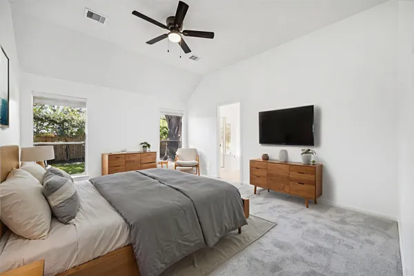 a bedroom with a bed and a flat screen tv