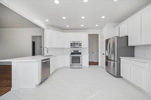 a kitchen with refrigerator cabinets and stainless steel appliances