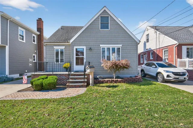 a front view of a house with a garden and patio