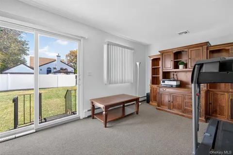 a living room with furniture pool table and a fireplace