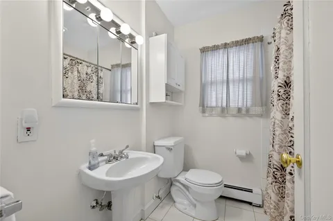 a bathroom with a sink toilet and a mirror