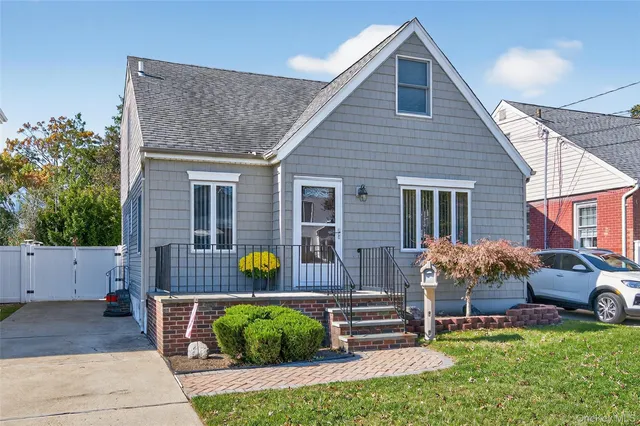 a front view of house with a garden and patio