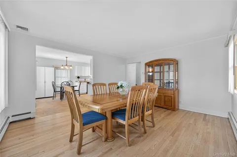 a view of a a dining room with furniture window and wooden floor