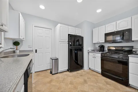 a kitchen with a sink appliances and cabinets