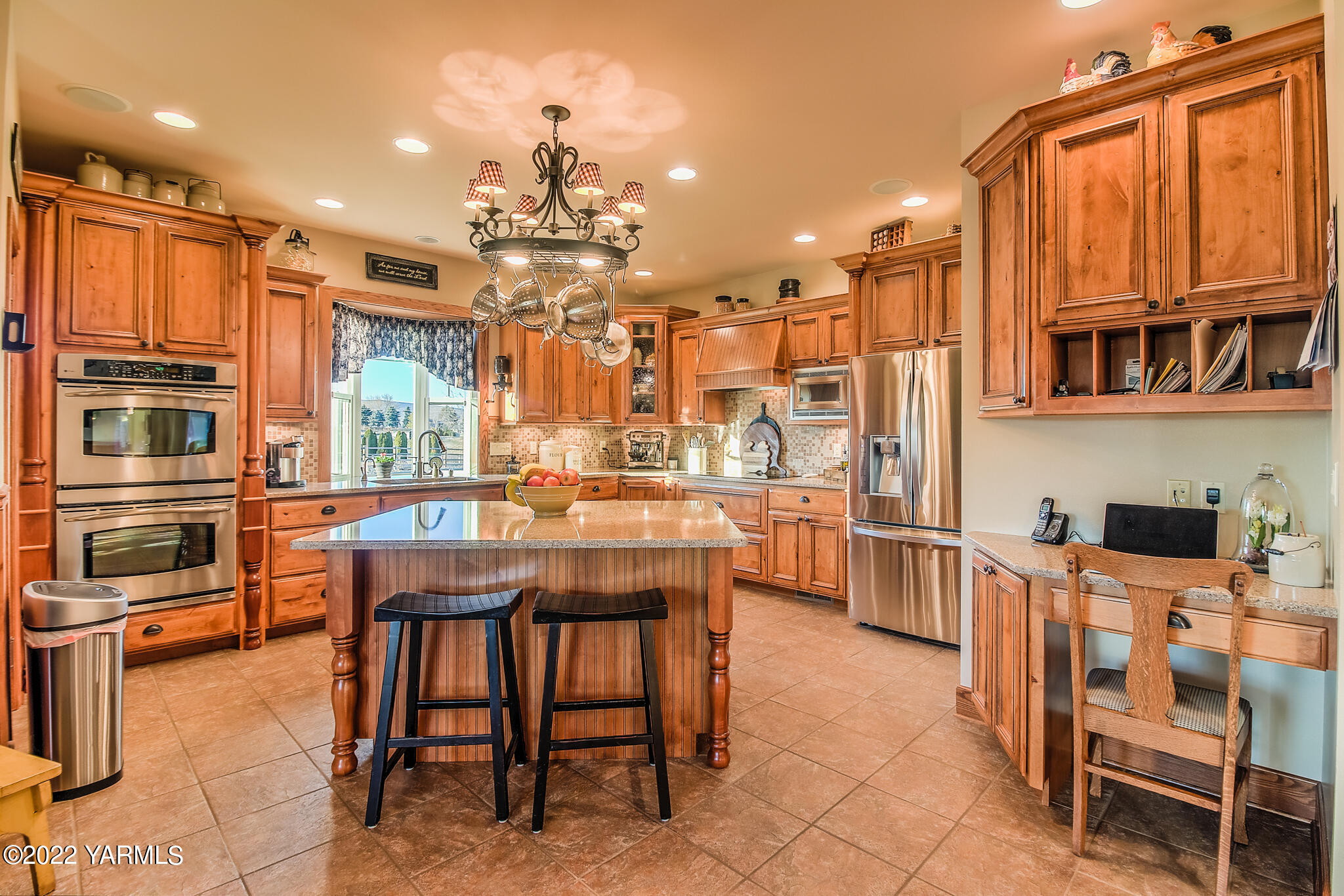 11392 Zier Road Yakima, WA 98908 - Photo 12 of 47 a kitchen with stainless steel appliances granite countertop a stove a sink dishwasher and a refrigerator with wooden cabinets
