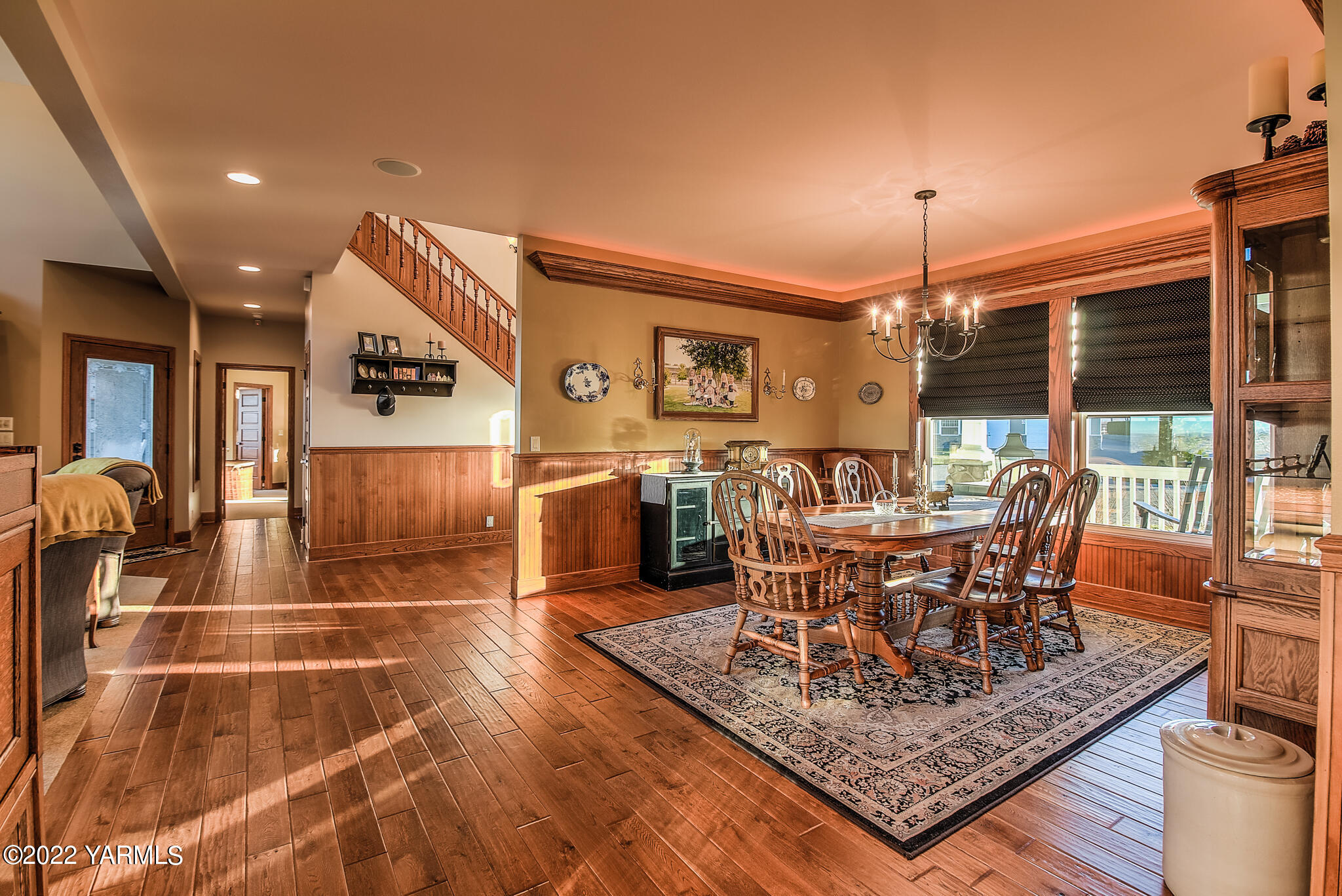 11392 Zier Road Yakima, WA 98908 - Photo 9 of 47 a dining room with wooden floor a chandelier a glass table and chairs